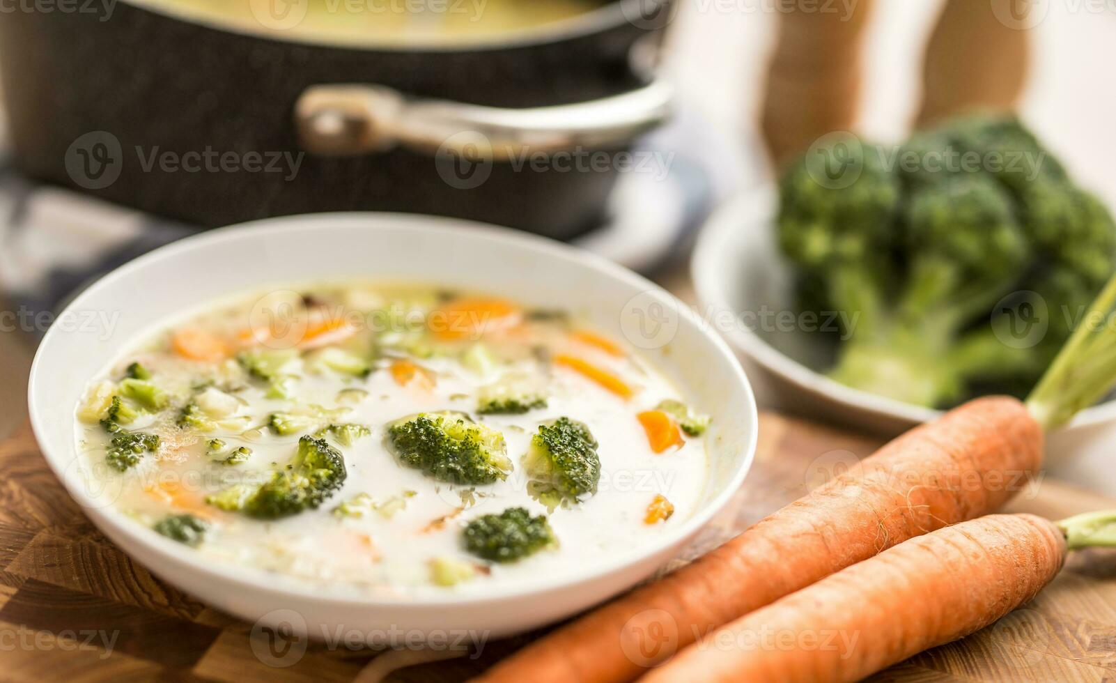 Vegetable soup from broccoli carrot onion and other ingredients. Healthy vegetarian food and meals photo