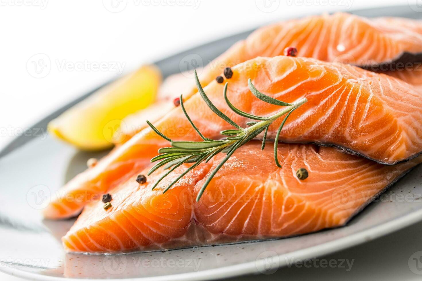 Salmon. Raw salmon steaks herb peper lemon on white background. photo