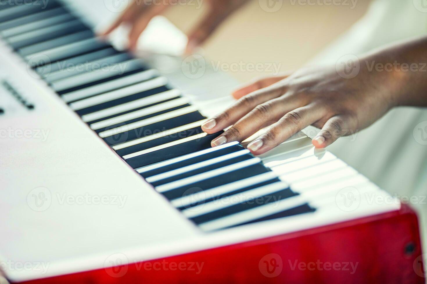 Close-Up a black woman hands playing on piano photo