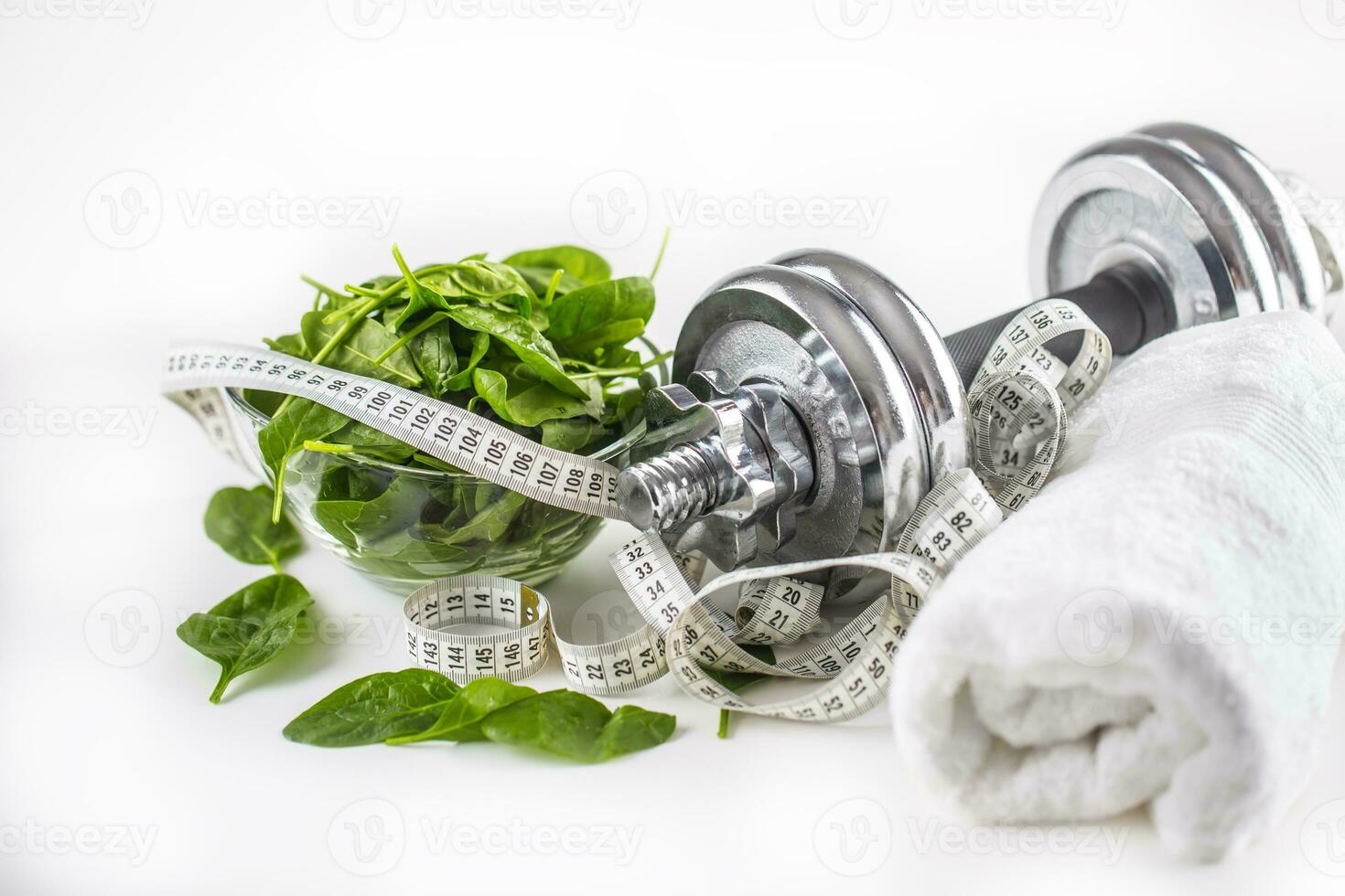 Spinach dumbbells and measure tape isolated on white background photo