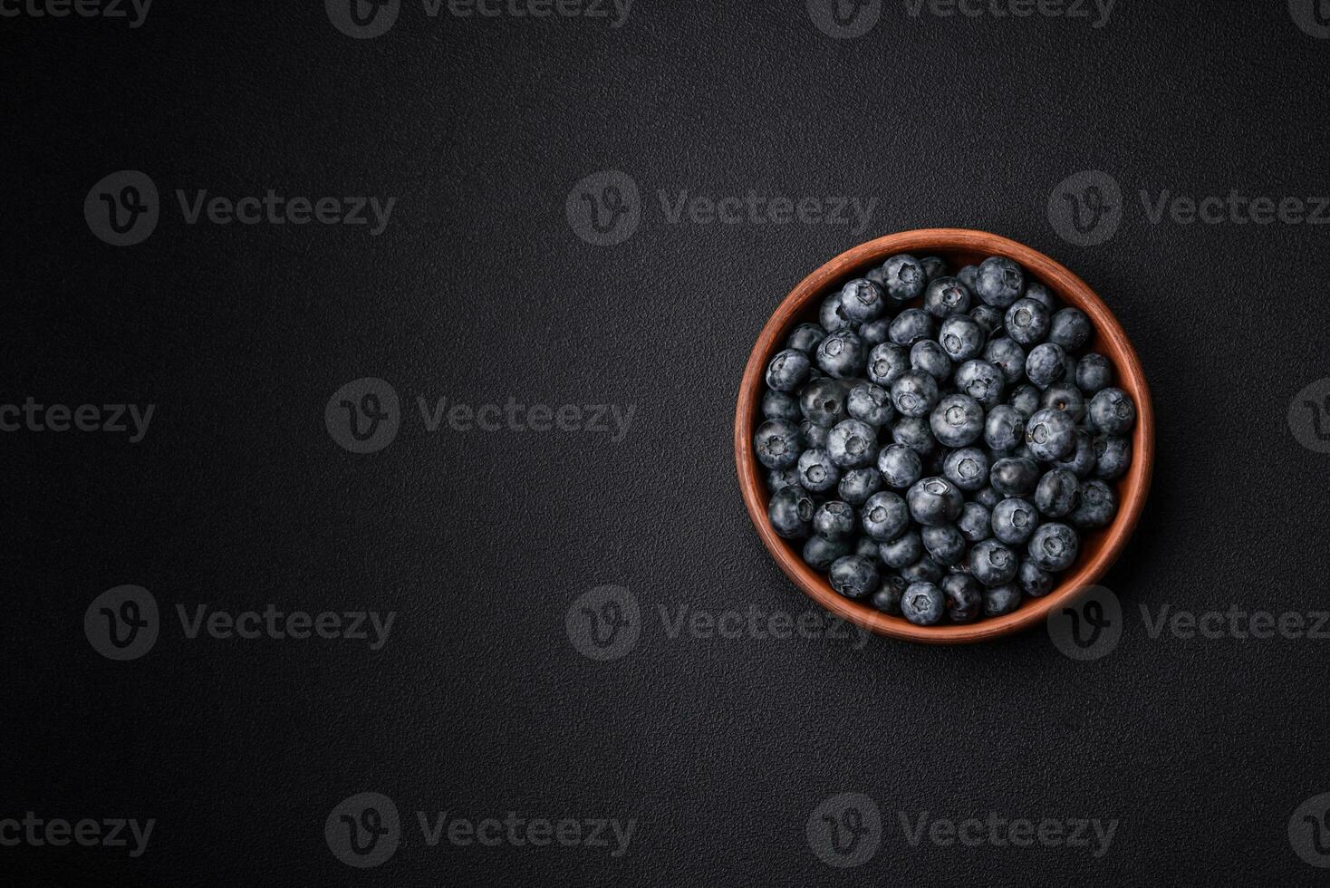 Delicious fresh sweet blueberries in a ceramic bowl. Vegan food photo