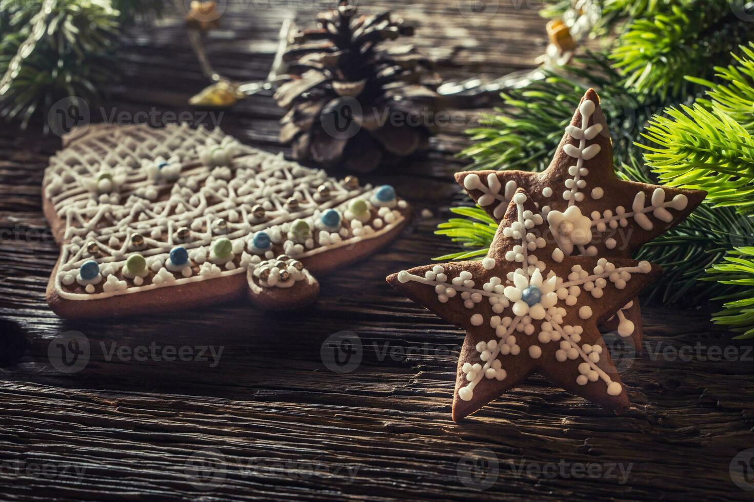 Christmas cake ginderbread. Christmas stars bell cakes and decoration on rustic oak table photo
