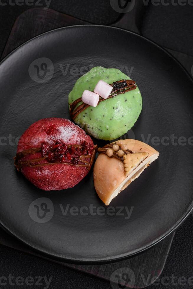 Delicious sweet colorful mochi desserts or ice cream with rice dough and toppings photo