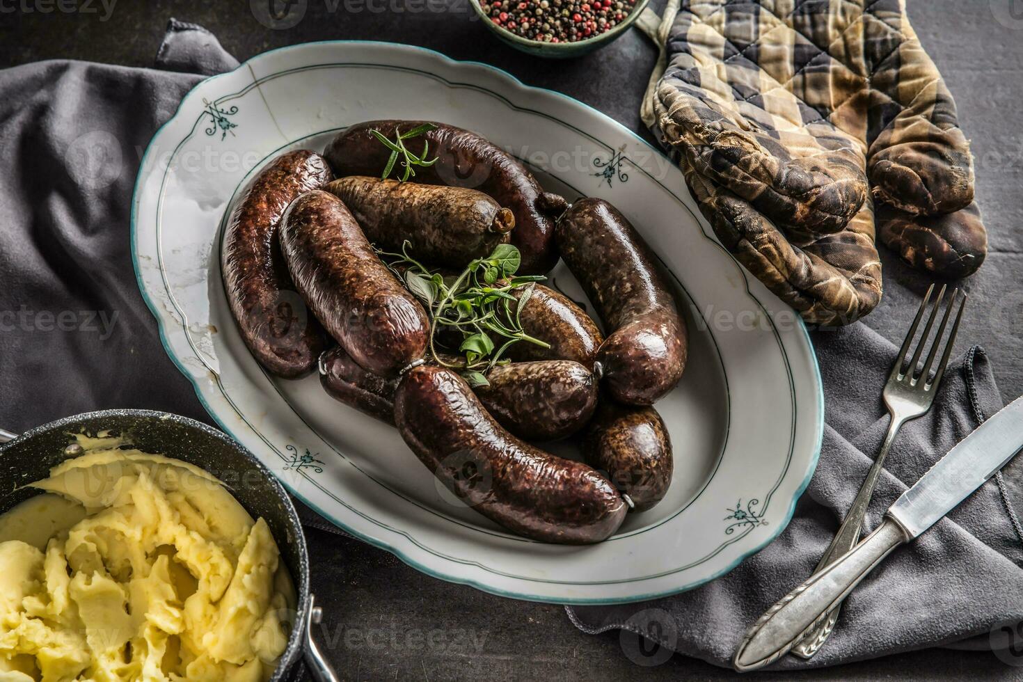 Roasted sausages in pan with rosemary. Traditional european food bratwurst jaternice or jitrnice photo