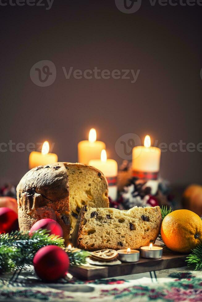 Delicious panettone on christmas table wit decorations and advent wreath and candles photo