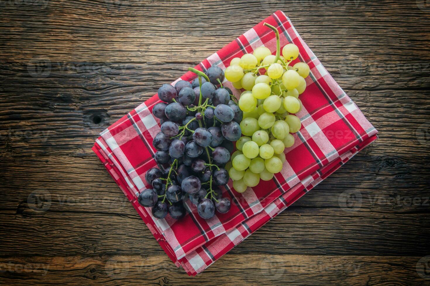 Grape. Bunch of multicolored grapes on rustic wooden table photo
