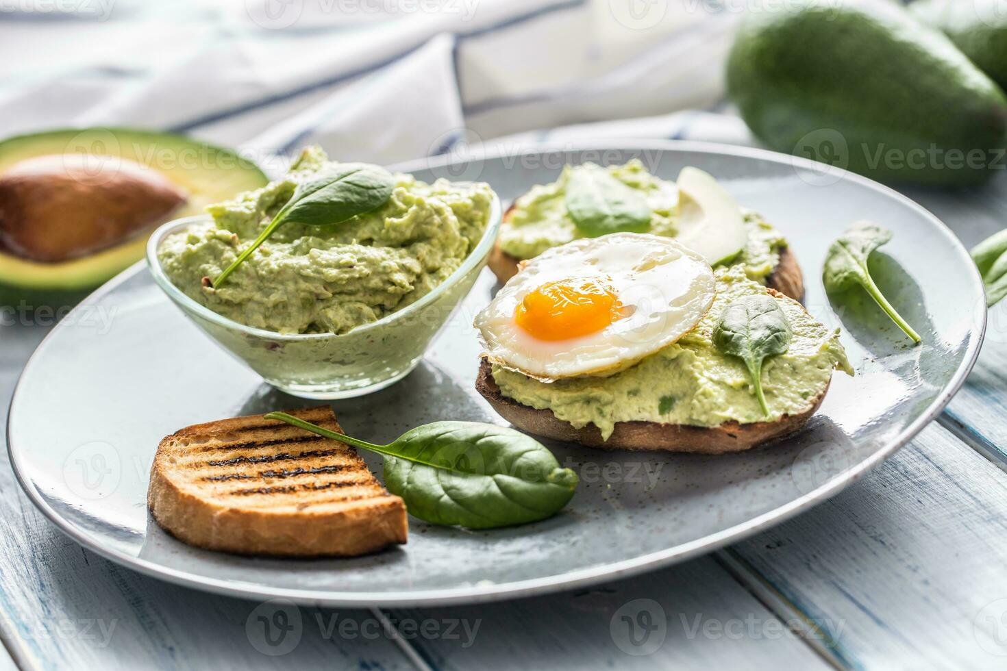 Toast bread with guacamole spread and egg. photo