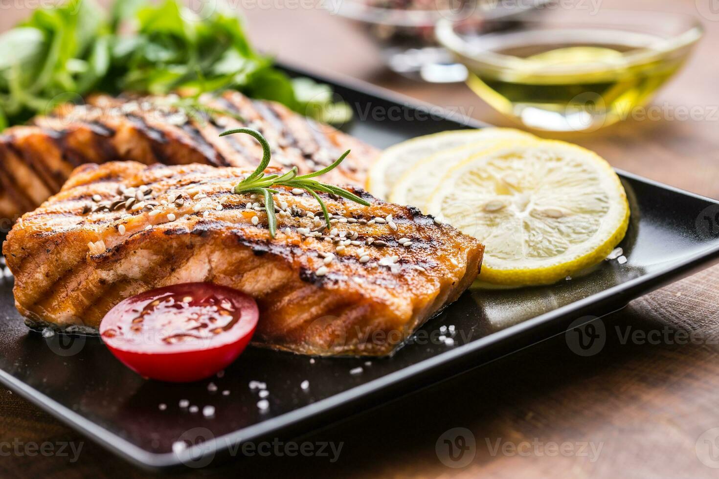 Grilled  salmon fillet with salad tomatoes and sesame photo