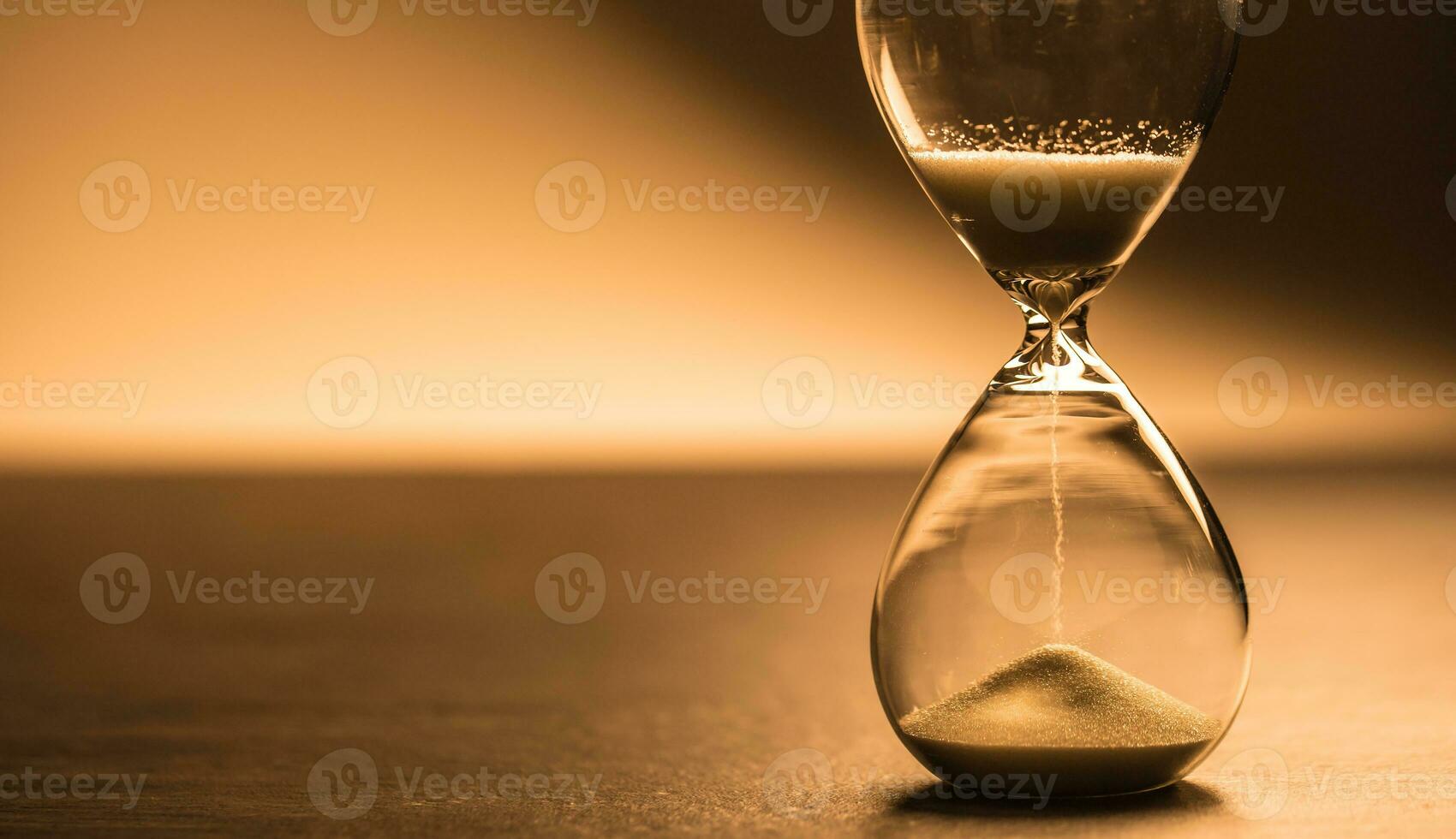 Modern hourglass in running time in studio lights photo