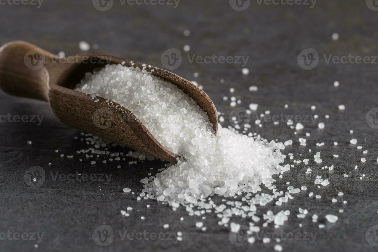 Crystaline sea salt in bowl and spoon - closeup photo