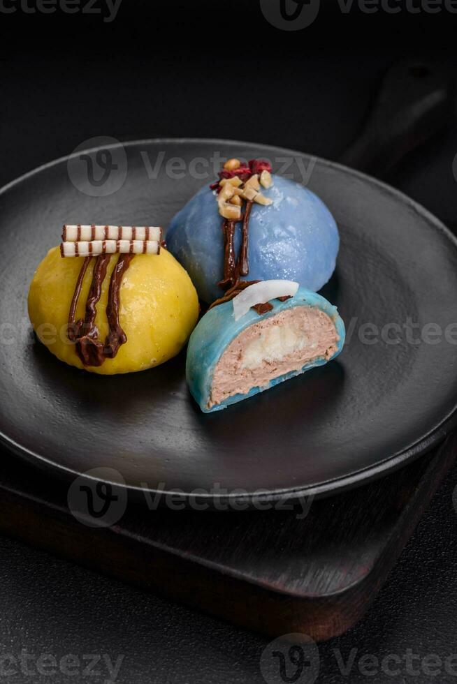 Delicious sweet colorful mochi desserts or ice cream with rice dough and toppings photo