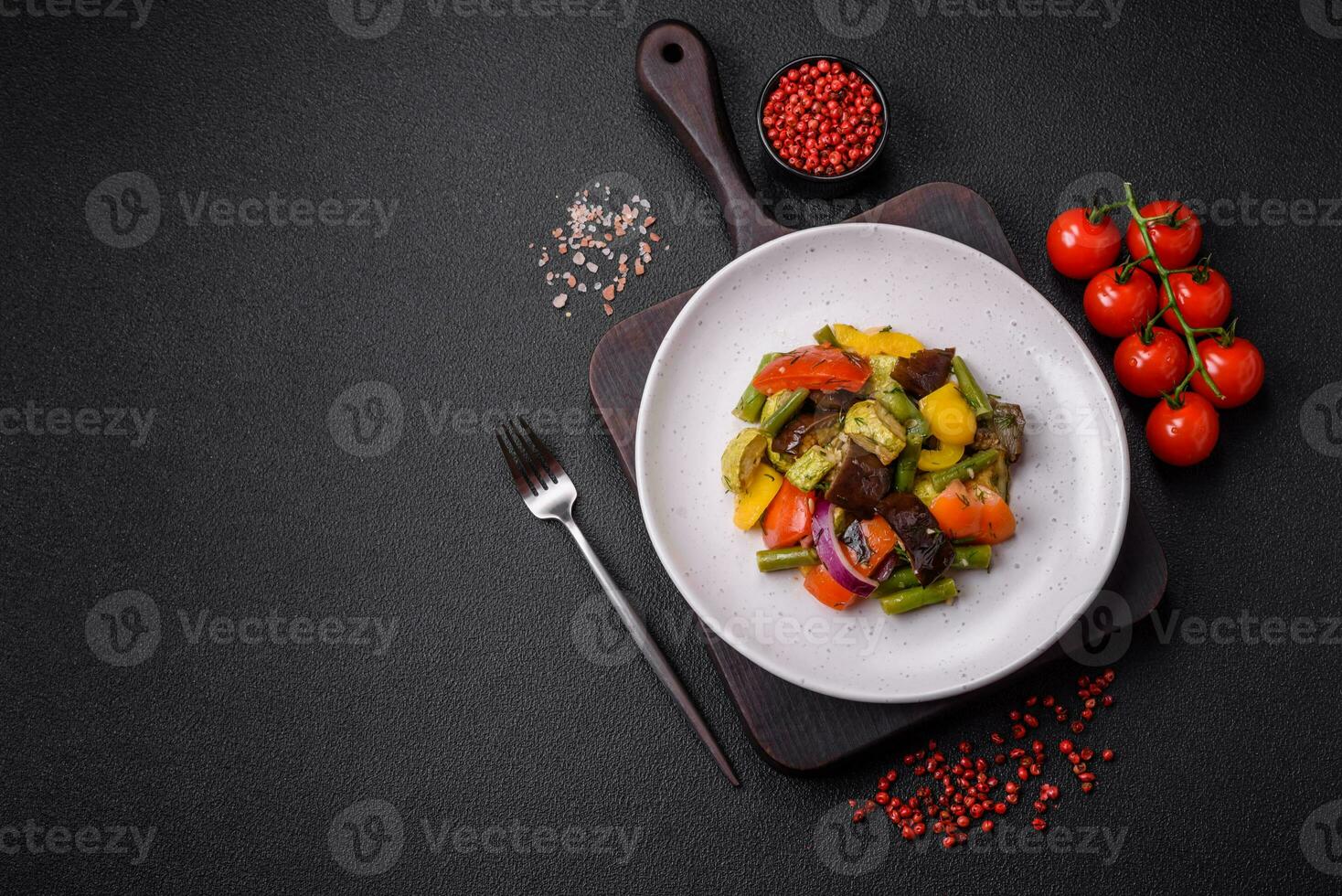 Delicious juicy fresh salad of baked eggplant, tomatoes, zucchini, onions photo