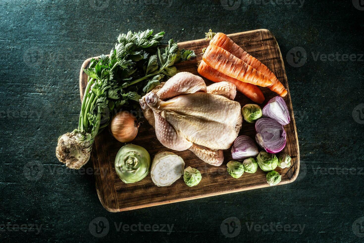 Raw chicken with fresh vegetables ready to cook broth. photo