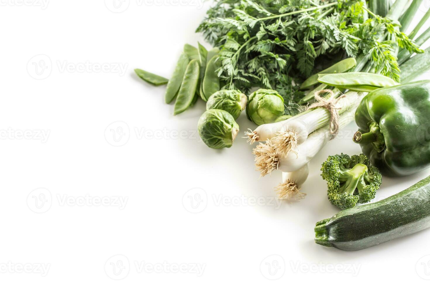 Green fresh vegetable isolated on white background. Onion cucumber peas broccoli zucchini and other healthy vegetables photo