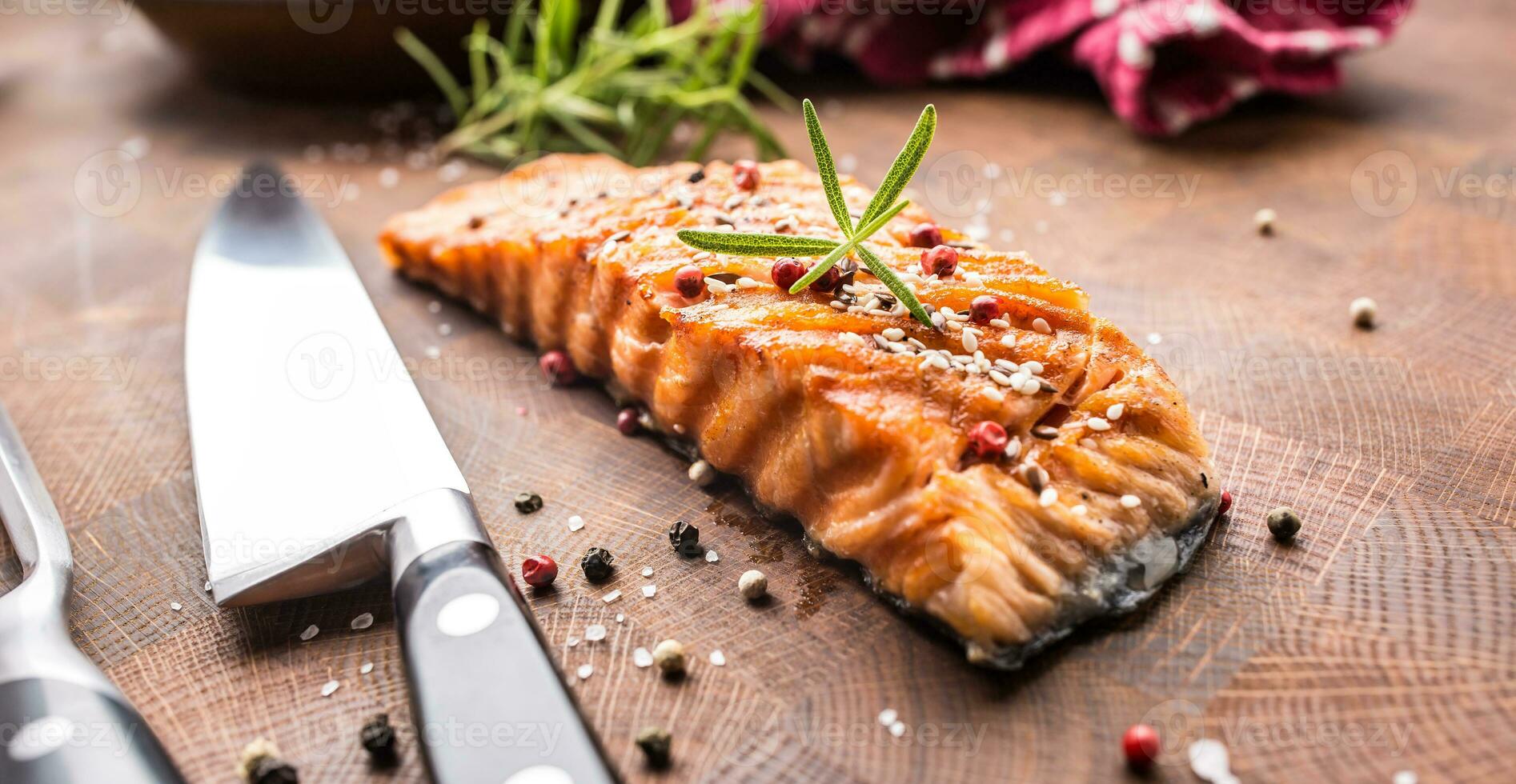 Salmon fillet grilled with salt pepper sesame and herb rosemary photo