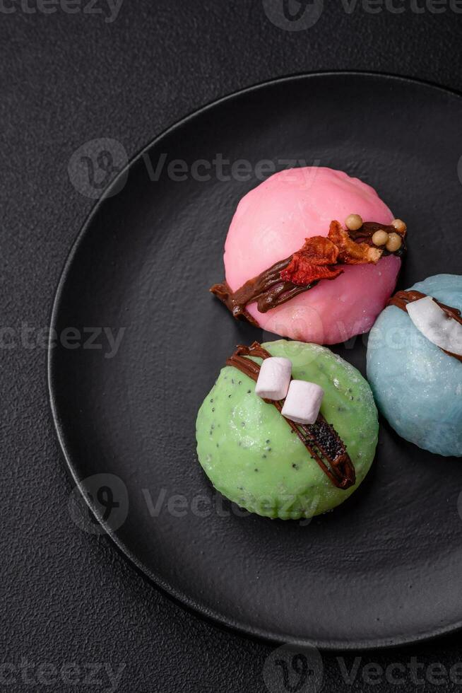 Delicious sweet colorful mochi desserts or ice cream with rice dough and toppings photo