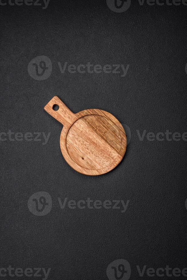 Empty round kitchen wooden cutting board in brown color photo