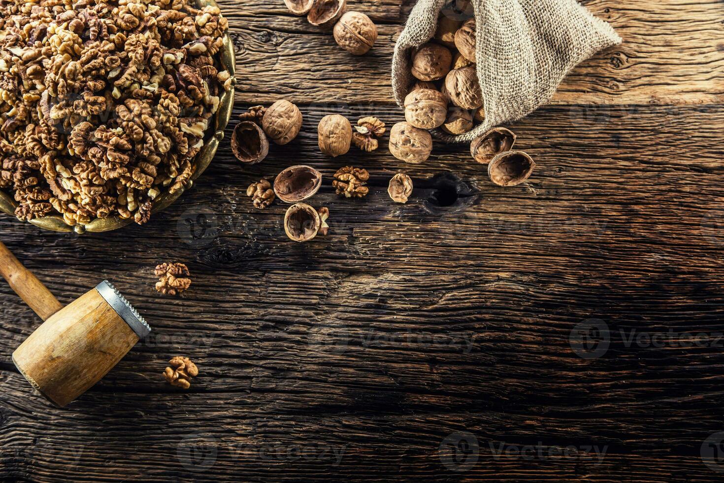 Walnut kernels whole walnuts in burlap sack and vintage bowl photo
