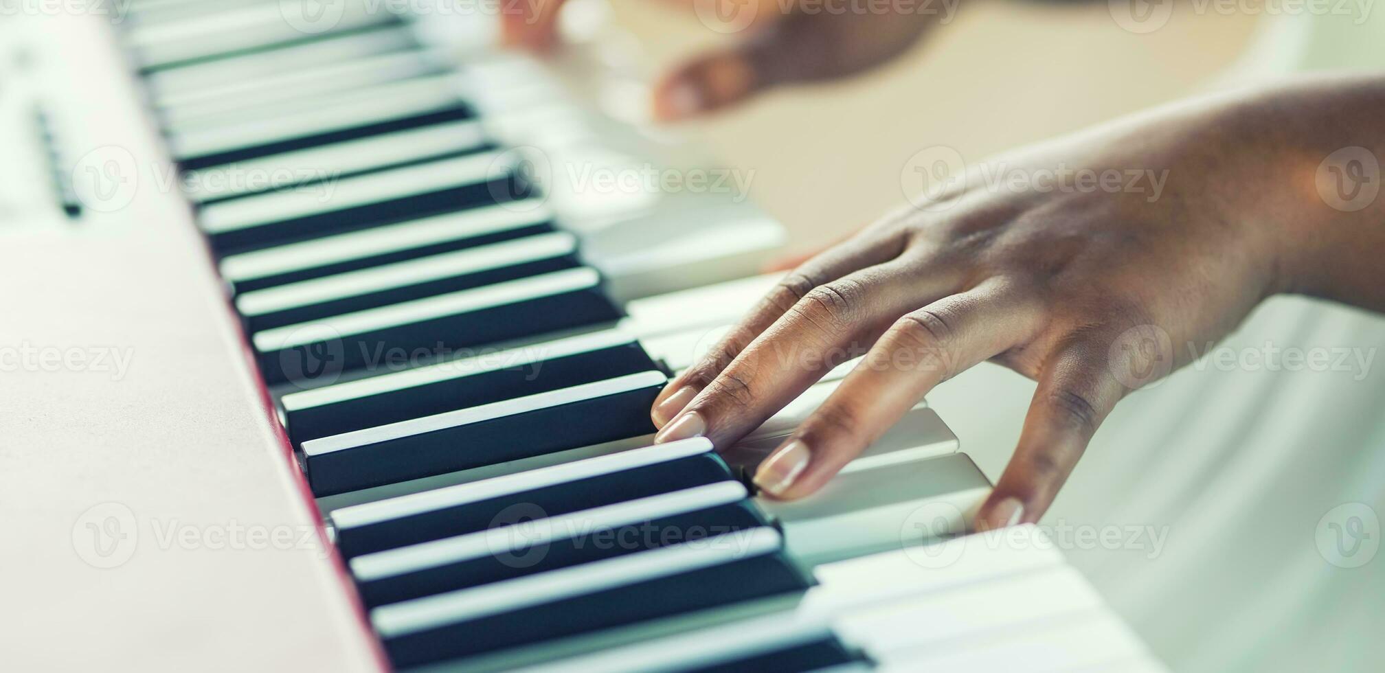 Close-Up a black woman hands playing on piano photo