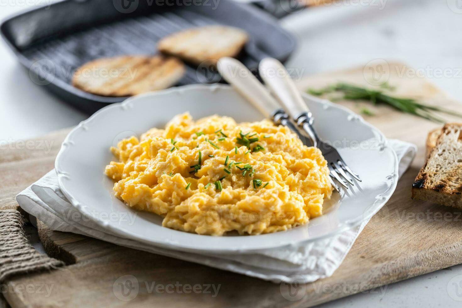 European breakfast with scrambled eggs with chive and toasts photo