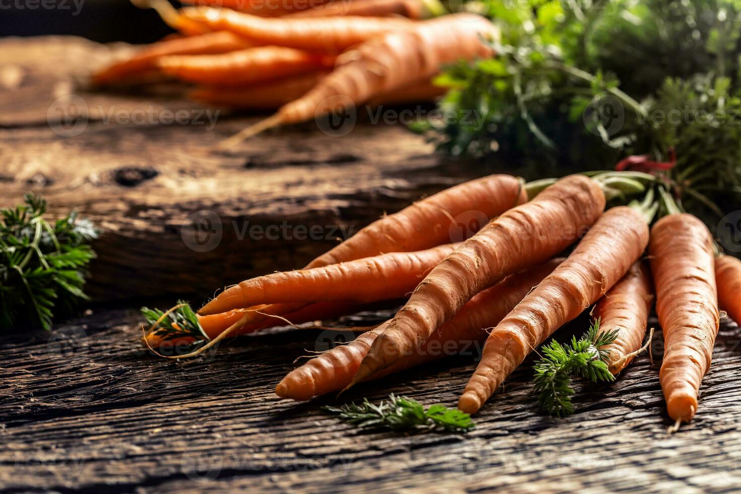 Fresh and sweet carrot on rustic wooden board photo