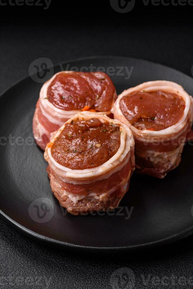 Delicious raw fresh pork or chicken meat rolls wrapped in bacon photo