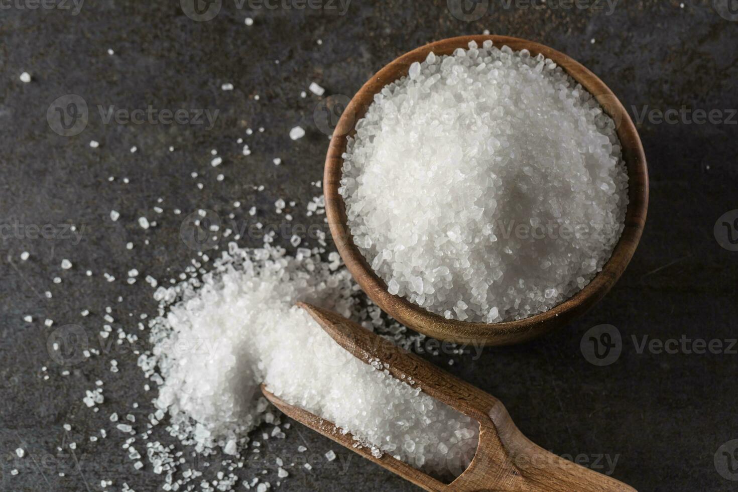 Crystaline sea salt in bowl and spoon - closeup photo
