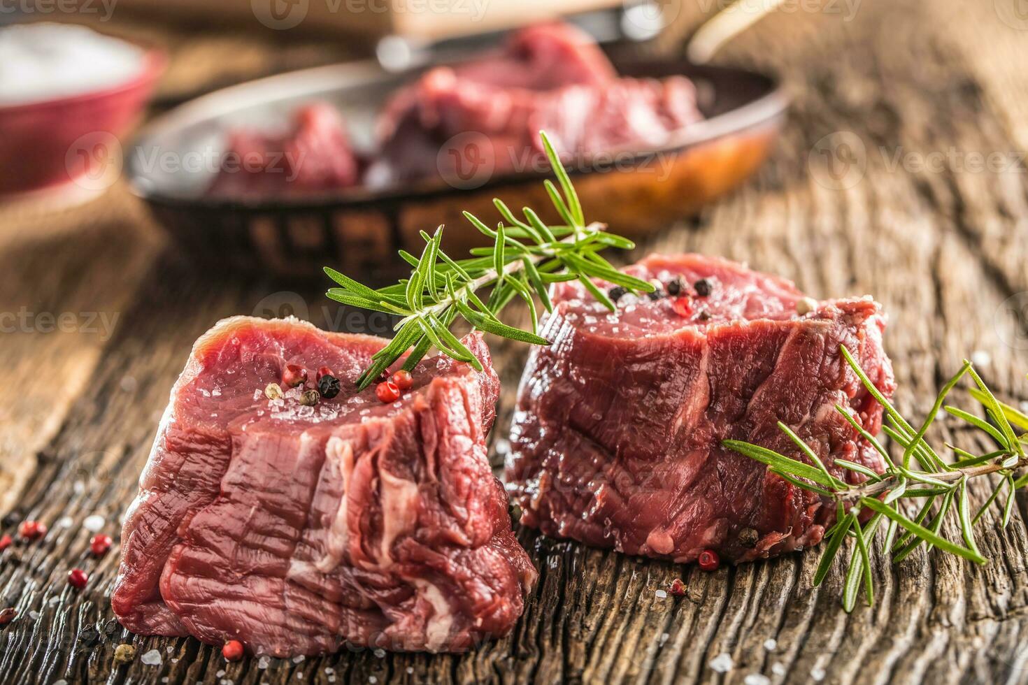 Close-up slices of beef tenterloin steak salt pepper and rosemary photo