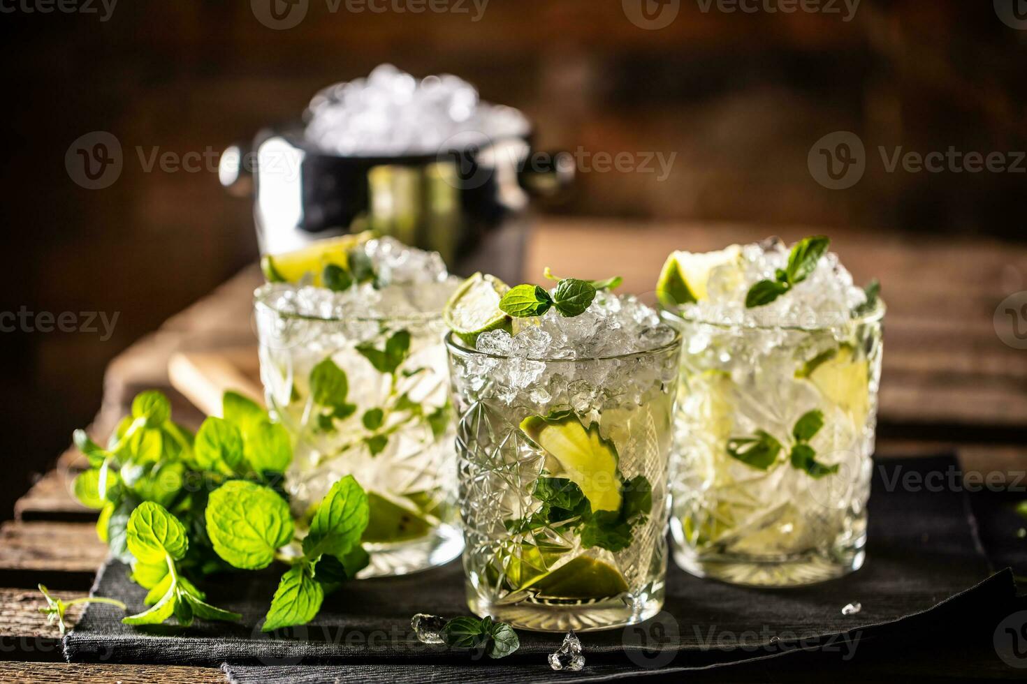 Mojito or virgin mojito long rum drink with fresh mint, lime juice, cane sugar and soda photo