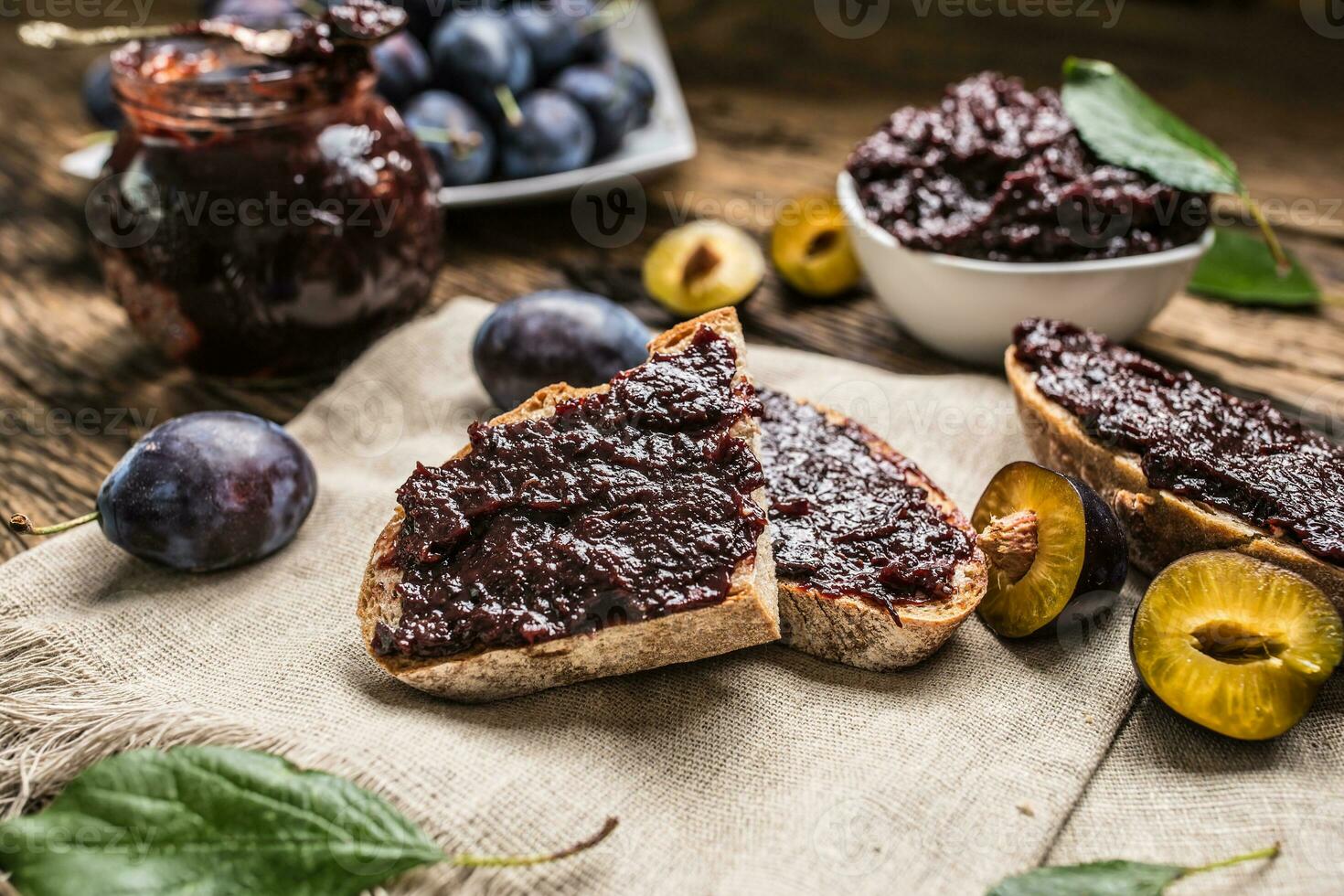 Breakfast from homemade plum jam bread and ripe plums. photo