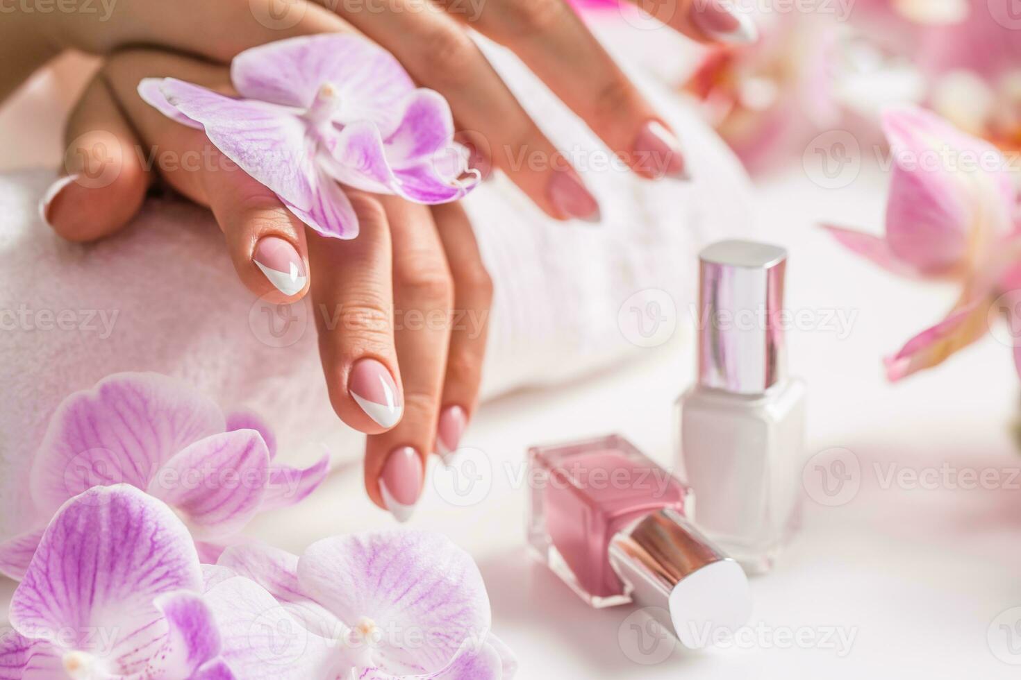 Beautiful nail manicure with decoration from pink orchid photo