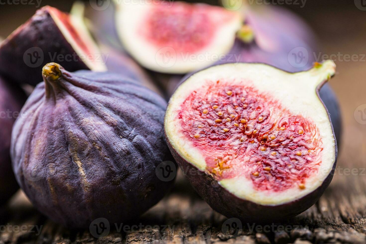 Figs. A few figs in a bowl on an old wooden background photo