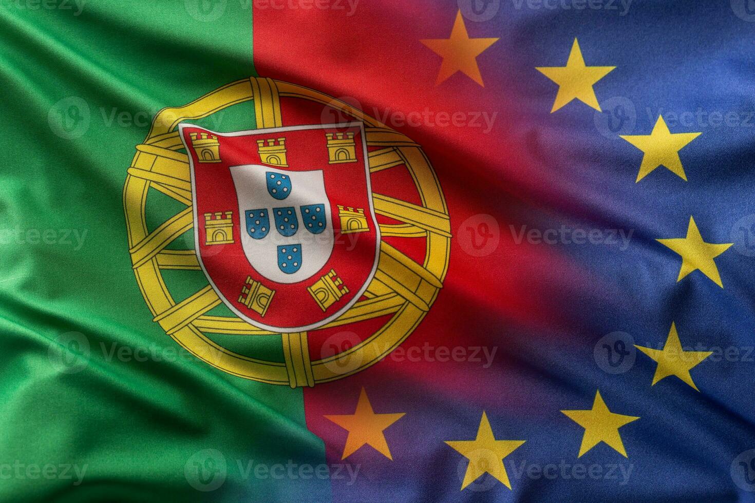 Flags of Portugal and EU blowing in the wind photo
