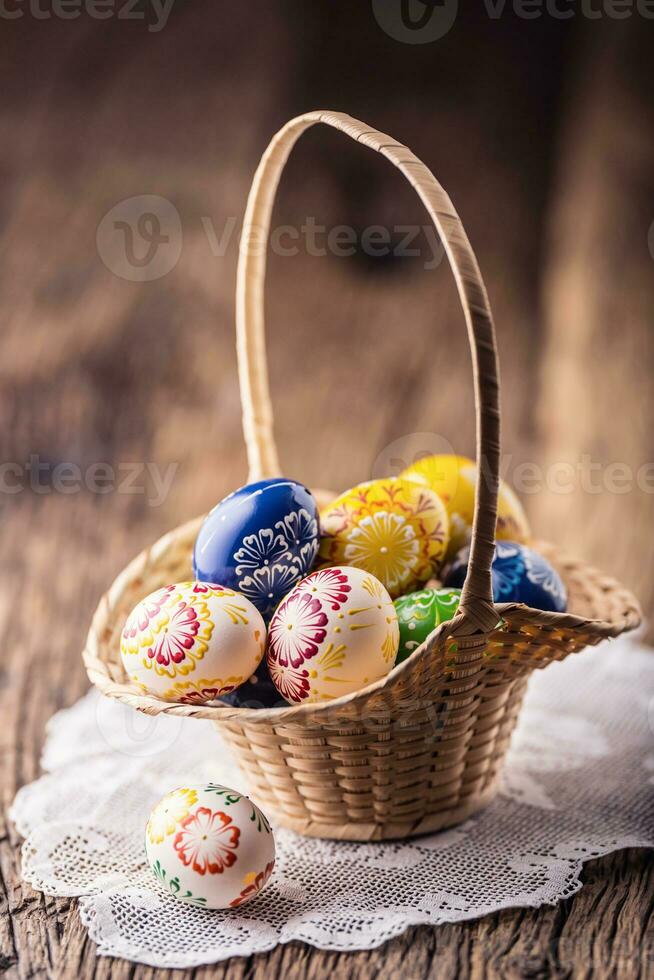Easter. Hand made painted easter eggs in basket and spring tulips. photo