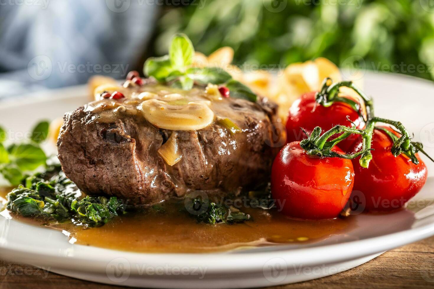 Cooked steak with peppercorn and sauce with healthy veg ready for serving photo