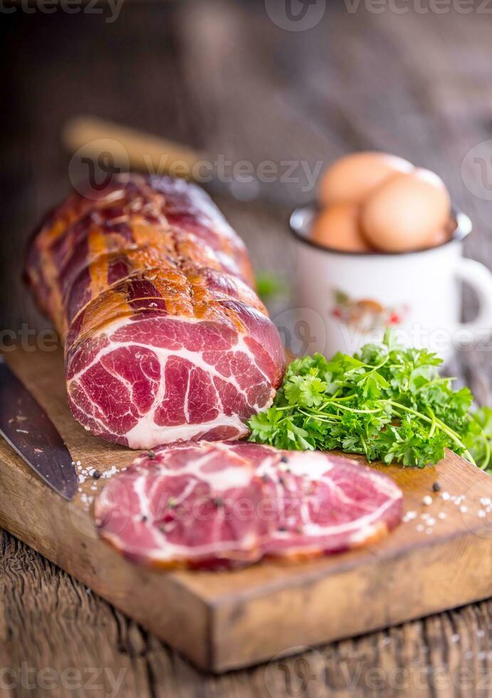 Pork meat.Pork chop smoked. Traditional smoked meat on oak wooden table in other positions photo