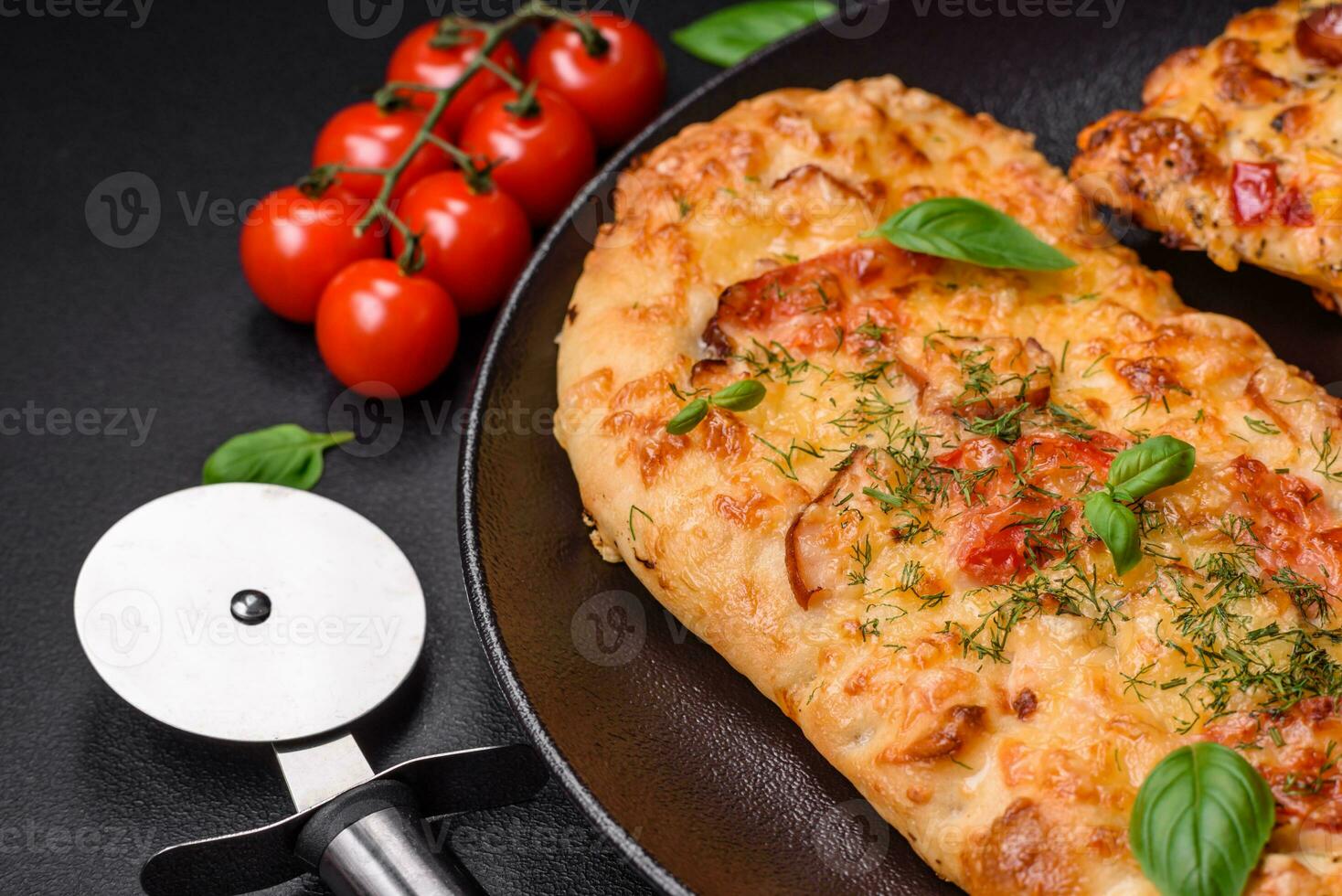 Delicious oven fresh flatbread pizza with cheese, tomatoes, sausage, salt and spices photo