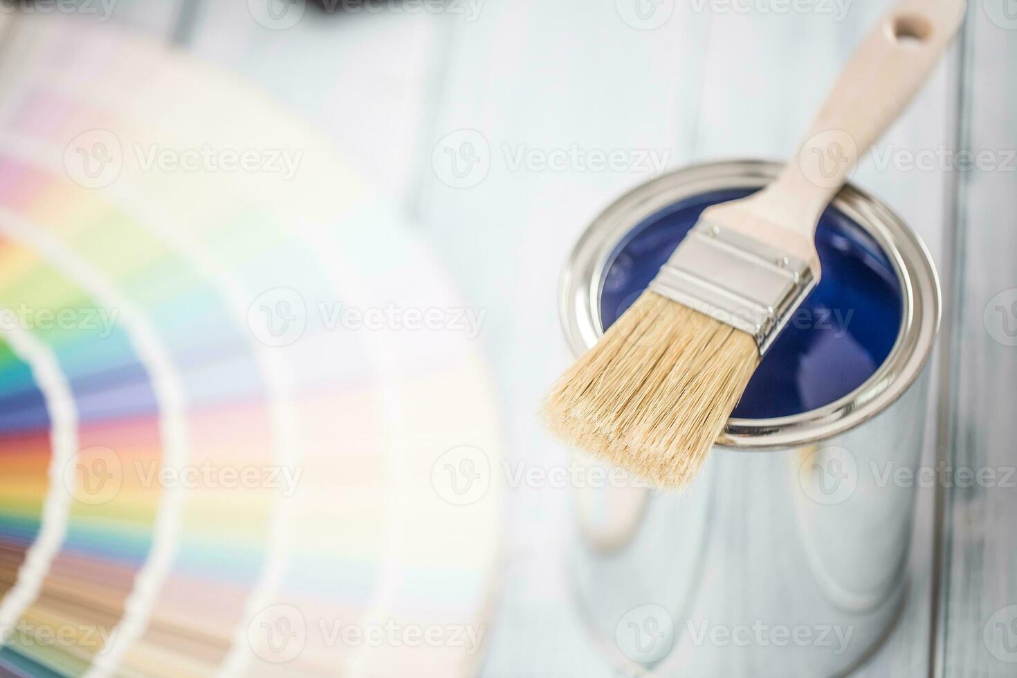 Paint cans brush and color palette on table. photo