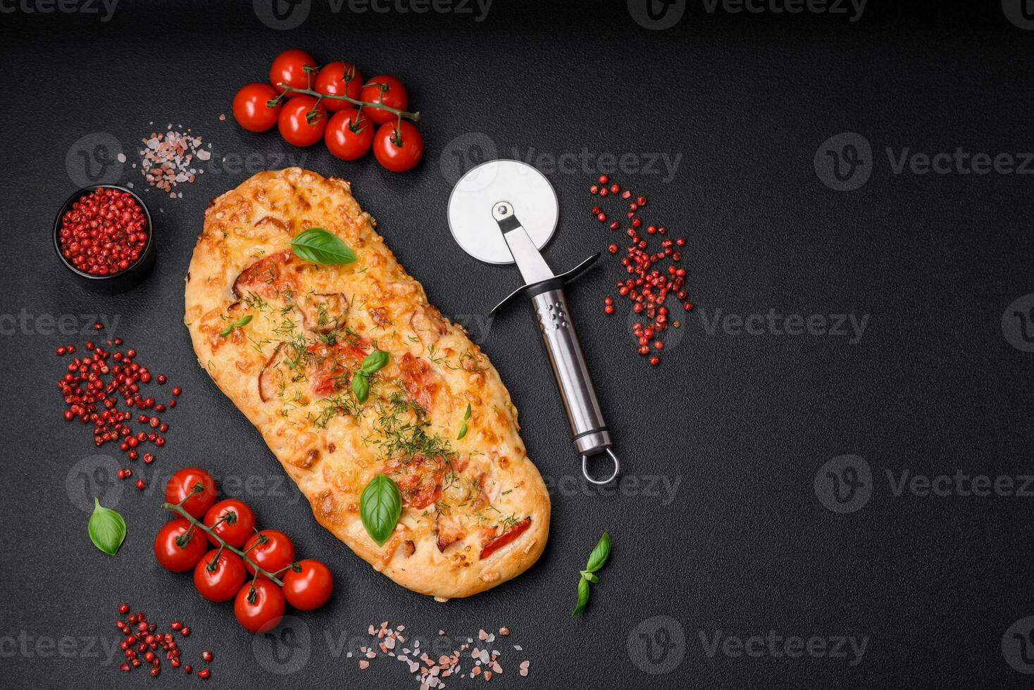 Delicious oven fresh flatbread pizza with cheese, tomatoes, sausage, salt and spices photo