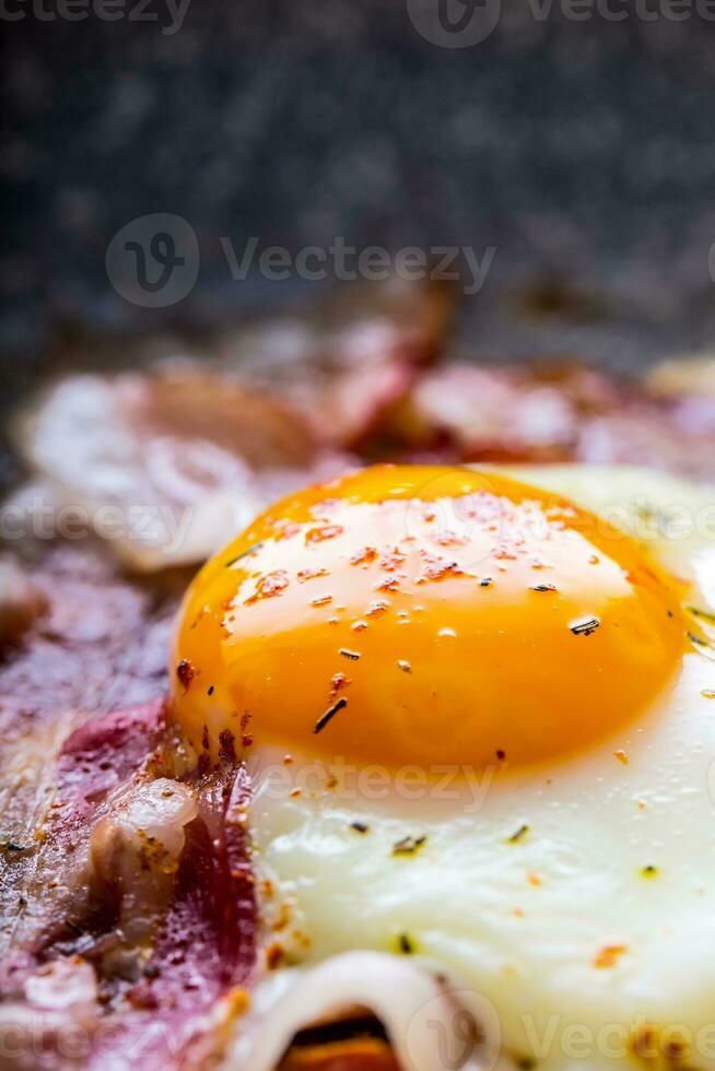 Ham and Eggs. Bacon and Eggs. Salted egg and sprinkled with red pepper. English breakfast. photo