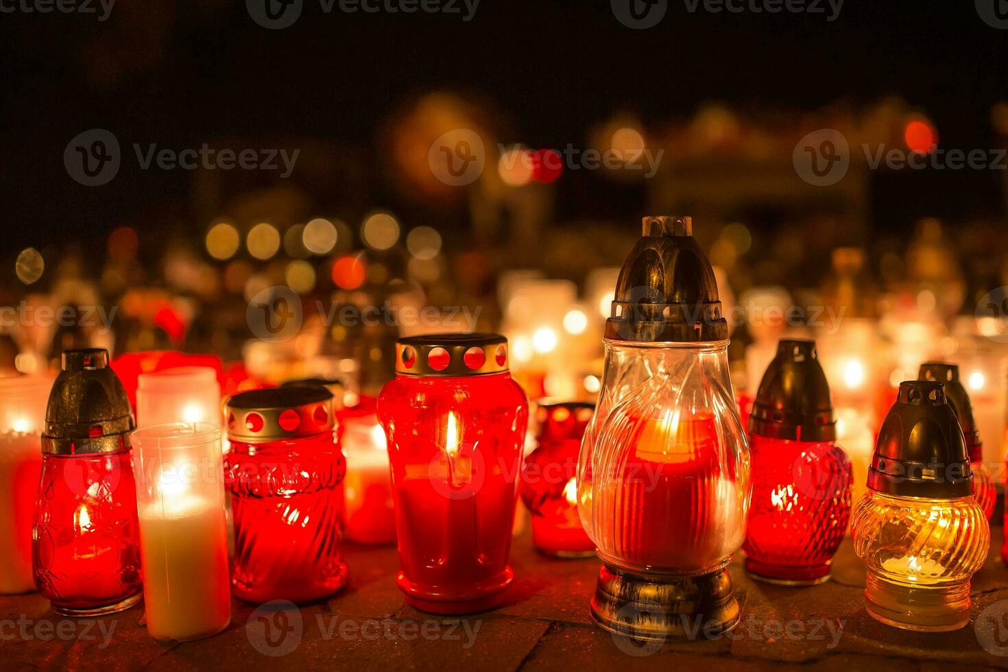 Many burning candles in the cemetery at night on the occasion souls of the deceased photo