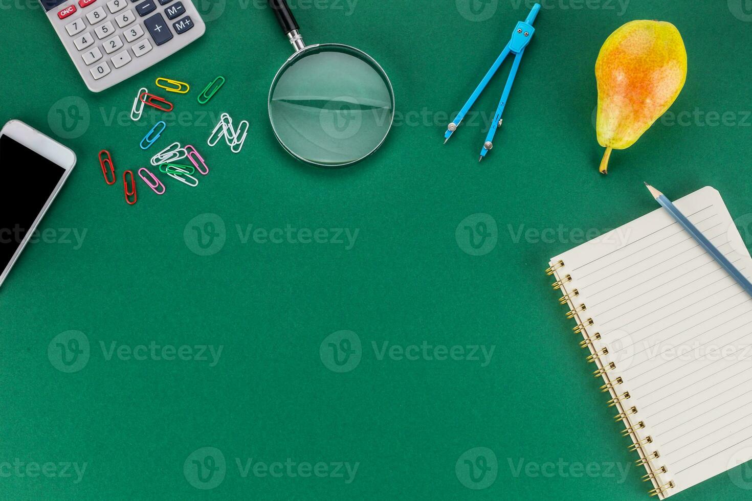 School supplies with copy space on green background photo