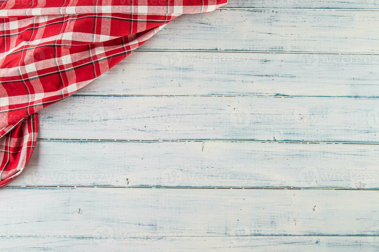 Top of view red checkered tablecloth on wooden table photo
