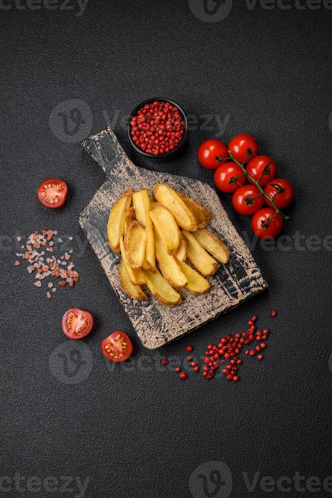 Delicious crispy potato deeps with salt and spices on a textured concrete background photo