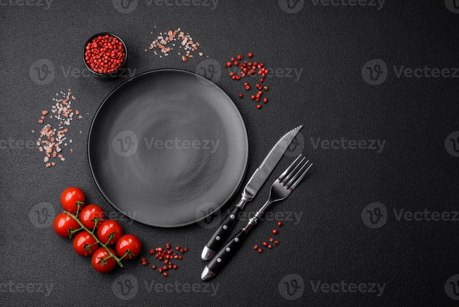 Empty black plate over dark stone background with copy space photo