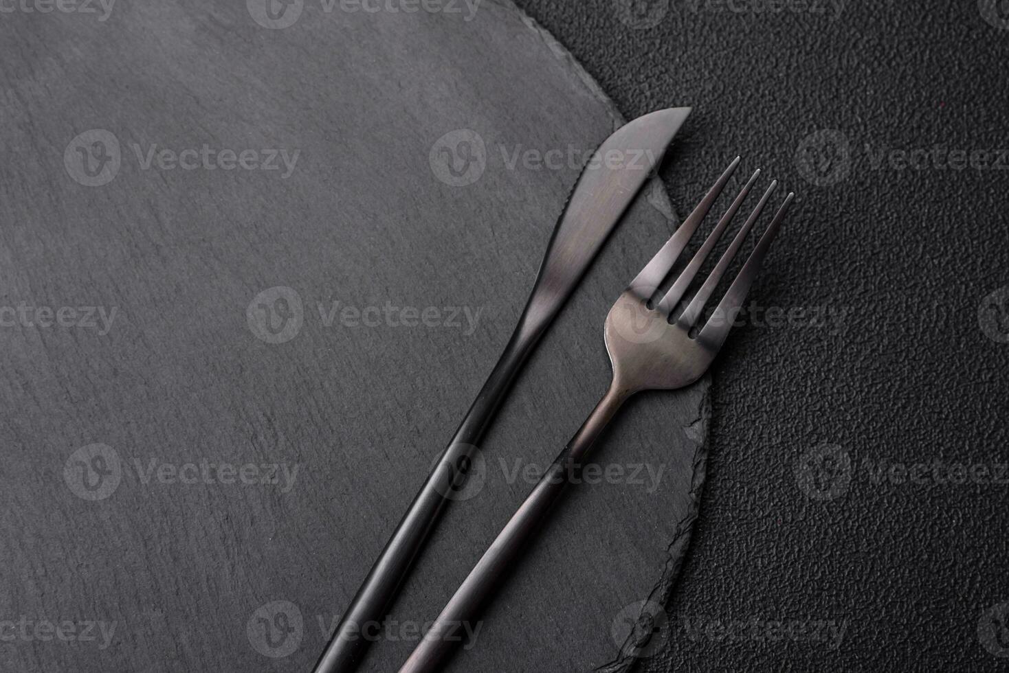 Empty black plate over dark stone background with copy space photo