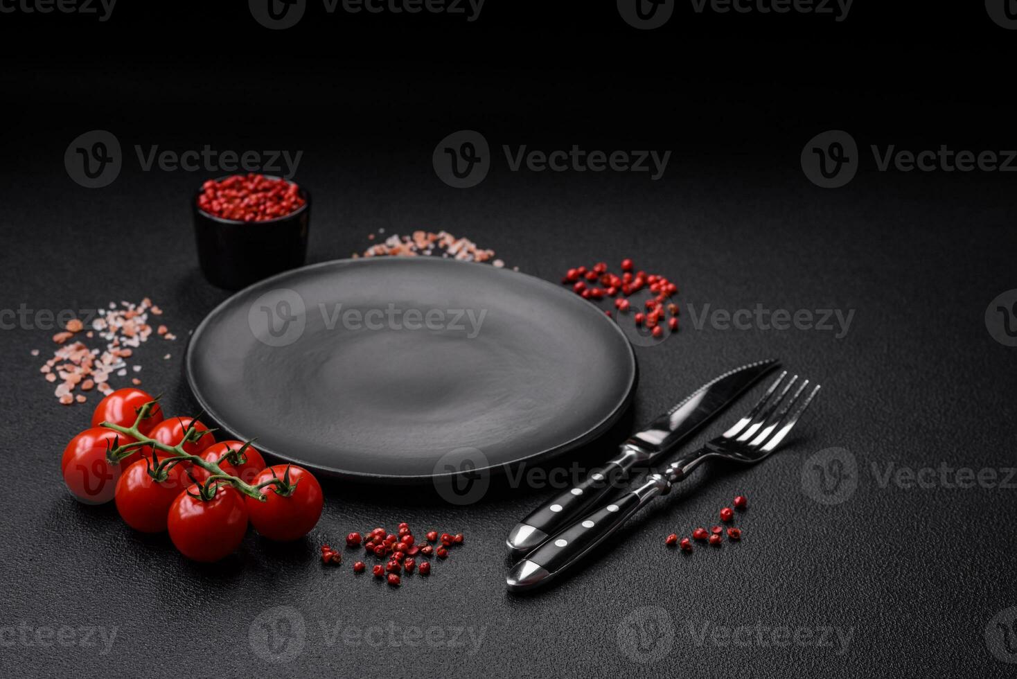Empty black plate over dark stone background with copy space photo