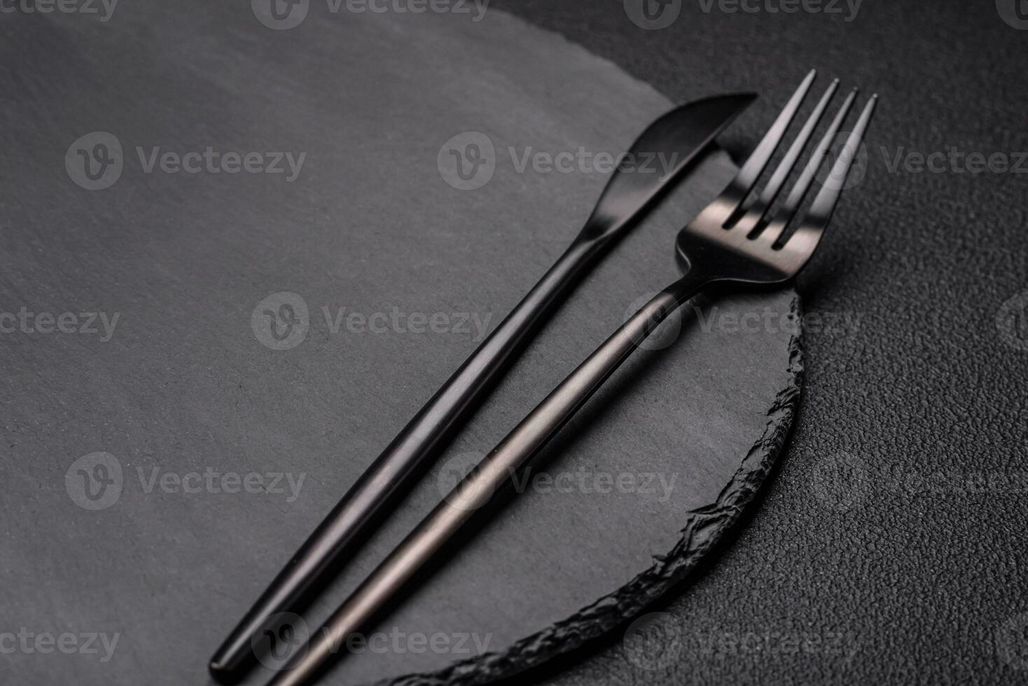 Empty black plate over dark stone background with copy space photo