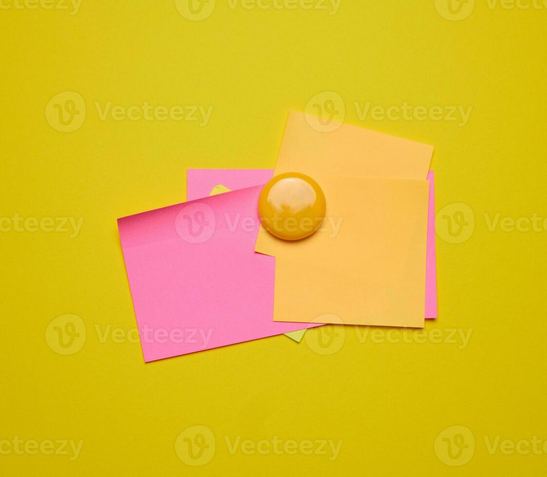 Colorful paper blank stickers attached with a button, space for notes and labels photo