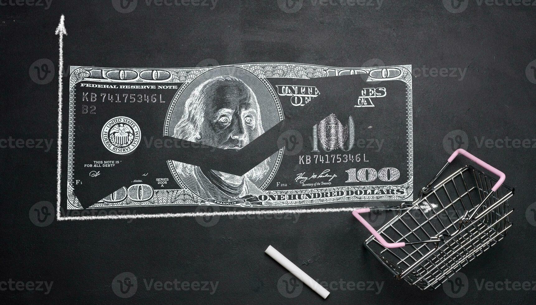 A miniature shopping cart and a dollar drawn in chalk with an increasing arrow, a rise in the price of a grocery set photo